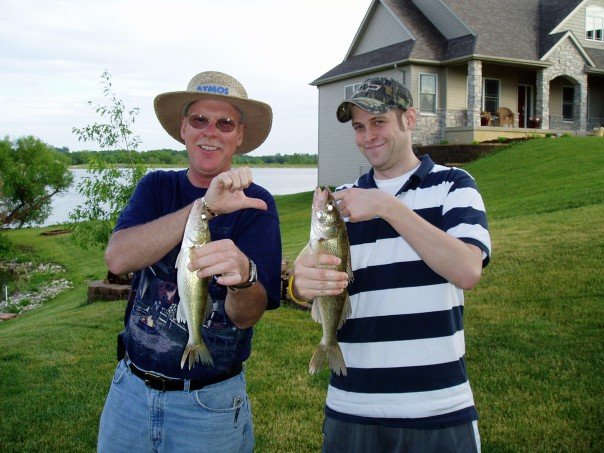 Two Men Holding up Large Fish