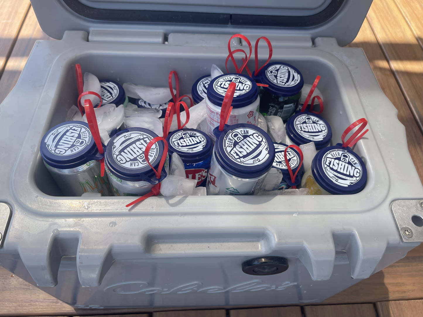 18 pack of beer can fishing game lids in a cooler