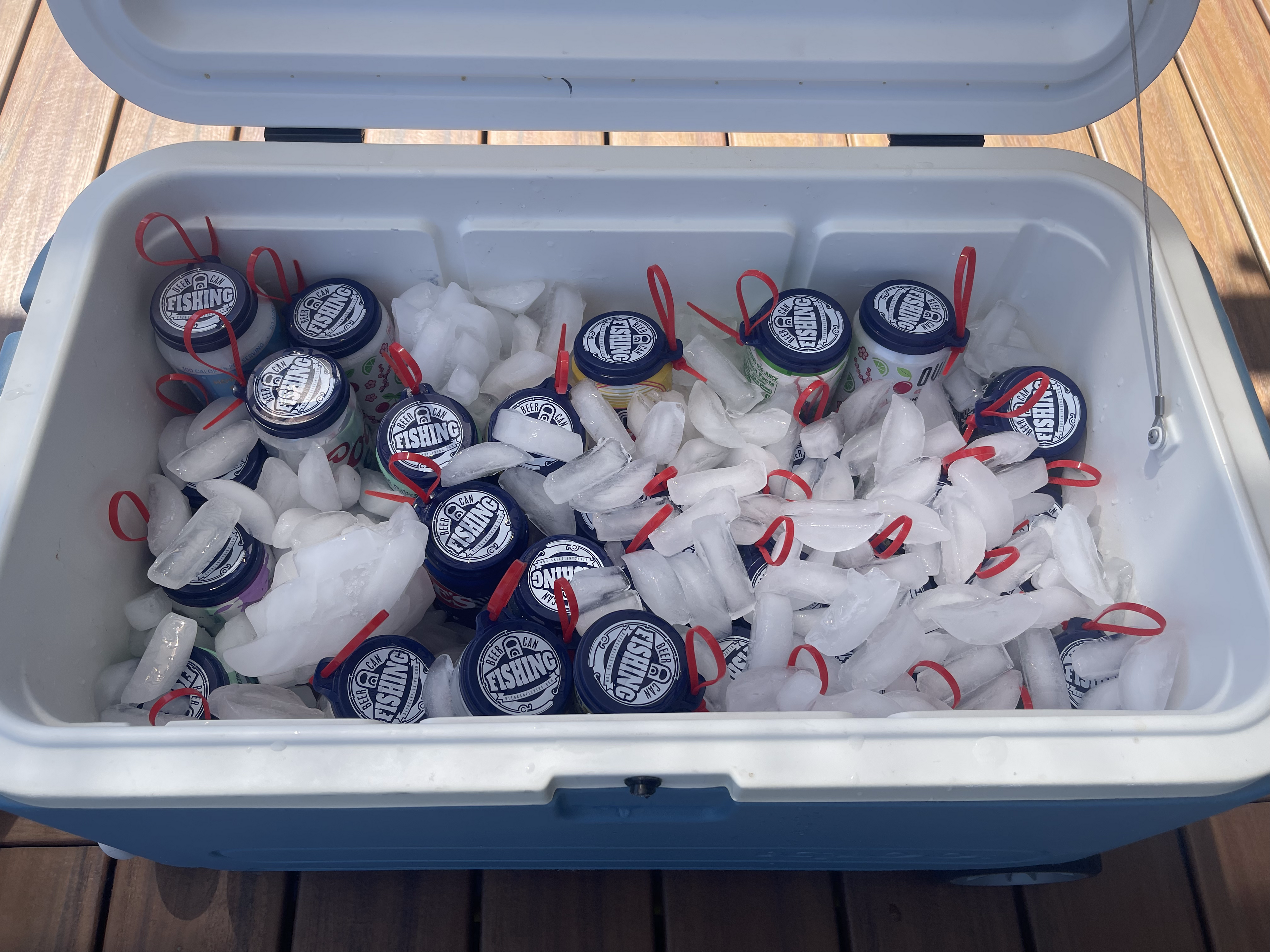 30 pack of beer can fishing game lids in a cooler