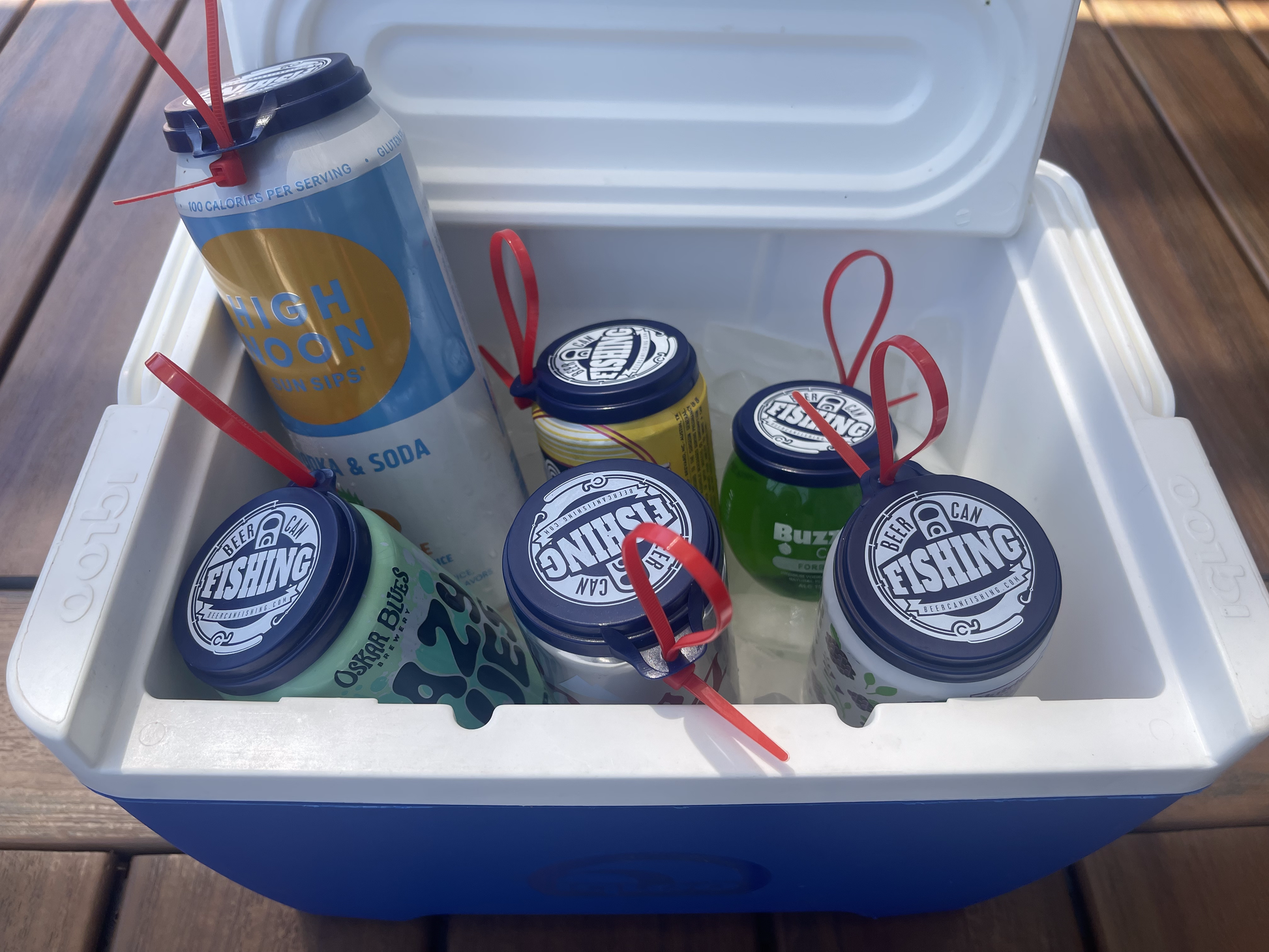 6 pack of beer can fishing game lids in a cooler